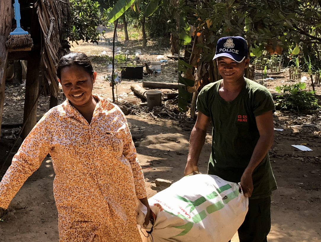 A man and a woman carrying a sack