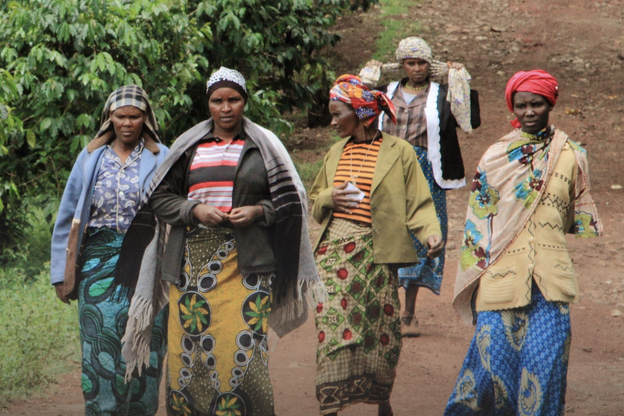 women walking down dirt path